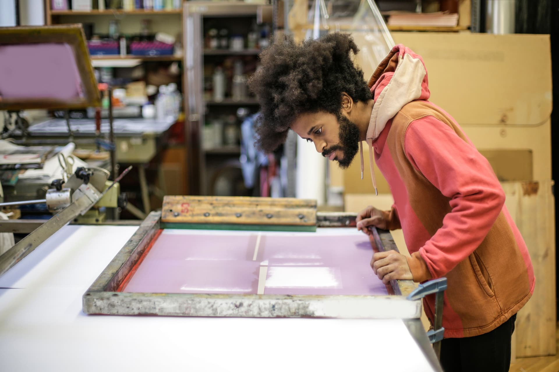 Printer preparing a mesh screen on a screen printing press
